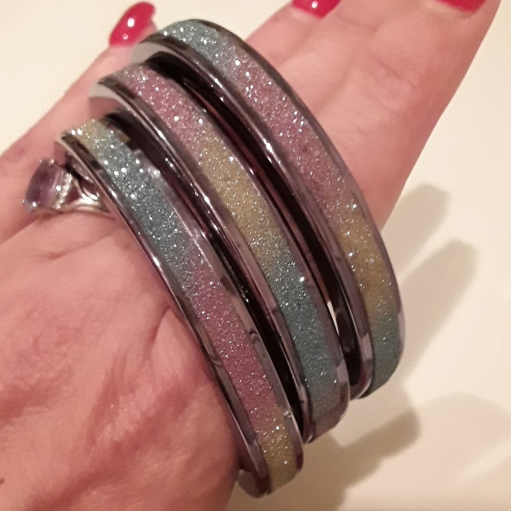 3 sparkling-yellow-blue-pink bangle bracelets.